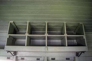 Vintage metal storage compartments with multiple empty cubbies, ideal for industrial or rustic decor. photo