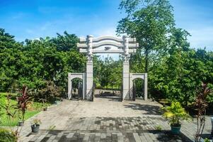 The serene Watu Gong Pagoda gate, surrounded by greenery and a clear sky, captures tranquility and heritage, often linked to Lunar or Chinese New Year. Indonesia, 17 November 2024 photo