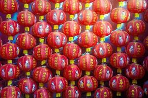 Red lanterns with Chinese characters and illustrations of children, symbolizing Lunar New Year celebrations. Indonesia, 17 November 2024 photo