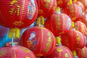 Red lanterns with Chinese characters and illustrations of children, symbolizing Lunar New Year celebrations. Indonesia, 17 November 2024 photo