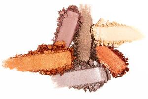Composition of eyeshadow smears on a light white background. Cosmetic texture, vibrant and layered. photo