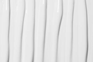 Texture of white cosmetic cream covering the entire image. Skincare background, soft and smooth surface. photo