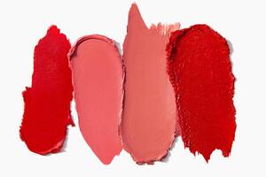 Lipstick texture and swatches in matte red shades on a light white background. Makeup smear composition. photo
