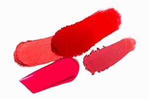 Range of red lipstick texture composition on a light white background. Cosmetic product smear smudge swatch sample. photo