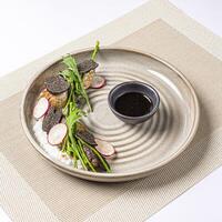 Pan Seared Foie Gras Creamy Risotto topped with Black Truffle Slice with Soy Sauce served in plate isolated on napkin side view of Japanese food on white background photo