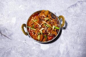 Beef Karahi topped with ginger and green chilli served in karahi isolated on grey background side view of indian, bangladeshi and pakistani food photo