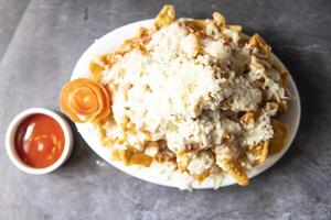 Chicken Nachos with ketchup served in tray dish isolate on grey background top view of indian, bangladeshi and pakistani food photo