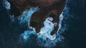 Waves crashing and splashing on the rocky shore, drone view video