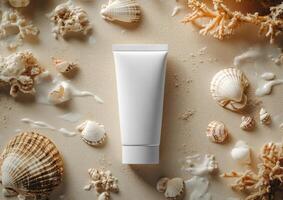 Mockup of cosmetic tube sunscreen spf cream 50ml lying on the sand surrounded by conch sea. Flat lay photo