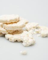 wheat rice breads, biscuits on a white background crumbled and whole photo