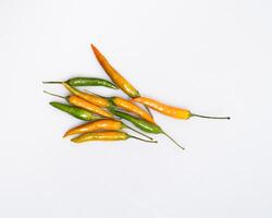 yellow red orange chili peppers lie on a white background photo
