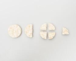 wheat rice breads, biscuits on a white background crumbled and whole photo