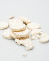 wheat rice breads, biscuits on a white background crumbled and whole photo