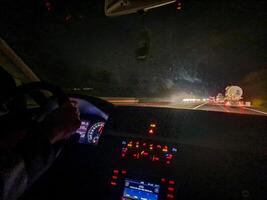Harrachov- Czech- 25 October 2024. Driver's view on the road, blurred in motion, night view from the driver's car,. photo