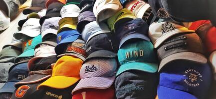 Variety of thrift hats on the display for sale at Pasar Senen. Jakarta, Indonesia - December 11 2024 photo