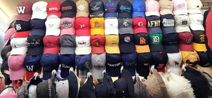 Variety of thrift hats on the display for sale at Pasar Senen. Jakarta, Indonesia - December 11 2024 photo