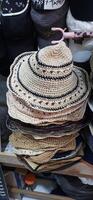 Variety of thrift hats on the display for sale at Pasar Senen. Jakarta, Indonesia - December 11 2024 photo