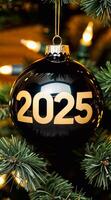 Large glossy black tree decoration hanging on tree with golden inscription 2025 photo