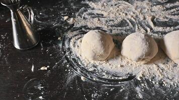 Preparation of pizza dough on a floured kitchen surface photo