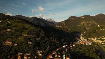 Aerial drone view of small Italian town with mountains range at background in summer, Tuscany. video