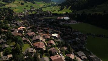 Cinematic drone shot flying over buildings in Gstaad, in Switzerland's Alps video