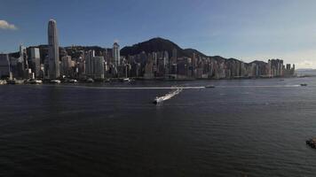 Drone aerial skyview in Victoria Harbour in Hong Kong Island, with a yacht on the bay video