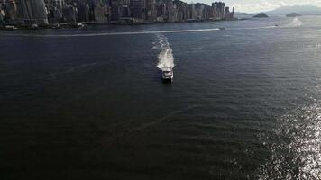 Drone aerial skyview in Commercial and residential buildings in Central Admiralty Hong Kong Island, a financial hub with a yacht on the bay video