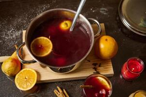 Warm mulled wine with oranges and spices for festive gatherings photo