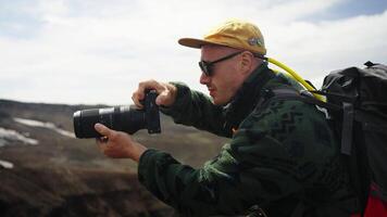 Professional Photographer With Camera Traveling In Mountains, Tourist Viewing Pictures On Display video