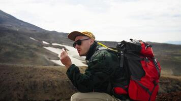 Curious Male Tourist Traveling In Mountains, Viewing Stone From Ground, Geologist Or Geographer video