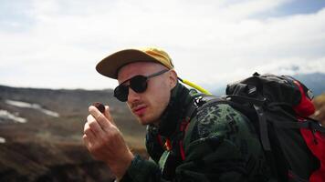 Portrait Of Stylish Male Tourist With Backpack And Sunglasses In Mountains, Man Viewing Stone video