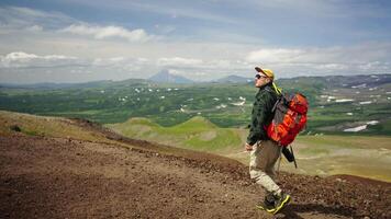 Backpacker With Camera Walking Alone In Mountains, Admiring Landscape With Mounts And Volcanoes video