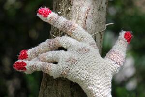 woman's hand knitted from woolen threads photo