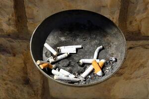 cigarette butts in an ashtray photo