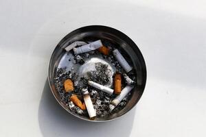 cigarette butts in an ashtray photo