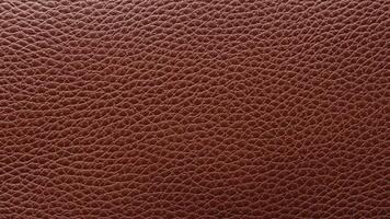 A deep mahogany leather texture with pronounced grain patterns, perfect for luxury branding, high-end decorative projects, and premium product visuals. photo