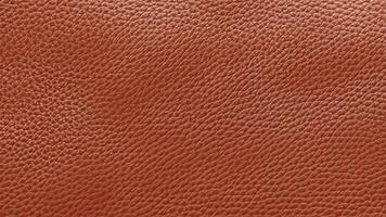 A vibrant orange leather texture with fine grain patterns and a glossy finish, offering a bold and dynamic look for luxury branding, artistic visuals, and product designs. photo