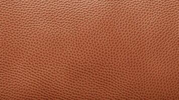A bold orange-brown leather texture with a rugged grain pattern and a dynamic surface, ideal for creative branding, modern decorative designs, and high-end product visuals. photo