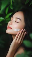Woman enjoying nature in a lush green environment with a serene expression on her face photo