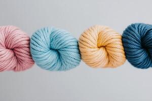 Various pastel colored threads woven together creating an artistic arrangement on a white background photo