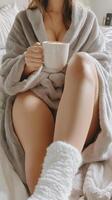 Cozy morning routine with warm beverage in plush robe on soft bed photo