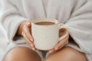 Warm beverage held in hands, cozy moment captured at home on a chilly day photo