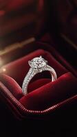 Elegant diamond ring displayed on plush red velvet background photo