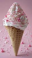 Colorful heart shaped ice cream cone with sprinkles on pink background photo