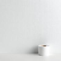 White toilet paper roll hanging on a plain wall in a modern restroom photo