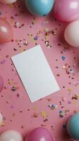 Colorful party setup with balloons and confetti around a blank card on a pink background photo
