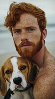 Red haired man with freckles and his beagle dog in a natural outdoor setting photo