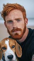 Red haired man with freckles and his beagle dog in a natural outdoor setting photo