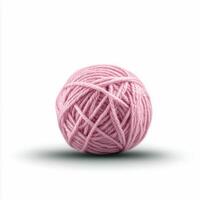 Soft pink yarn ball resting on a light surface with gentle shadow photo