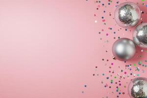 Pink background with shiny decorations and sparkling confetti for a festive celebration photo